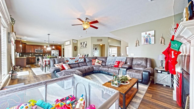 living room with dark hardwood / wood-style floors and ceiling fan