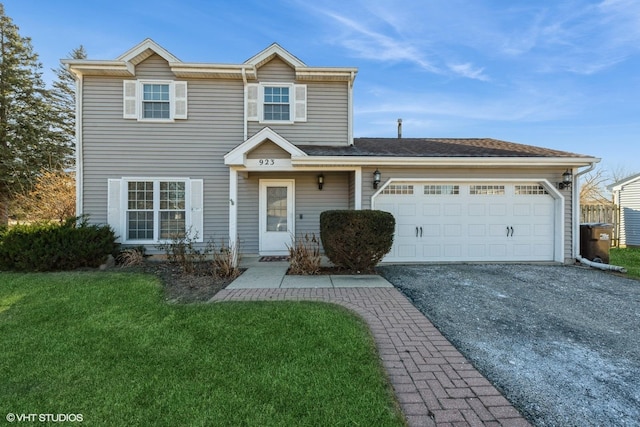 view of front of house with a garage and a front lawn