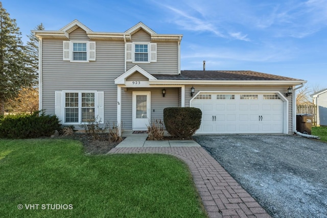 view of front facade with a front yard and a garage