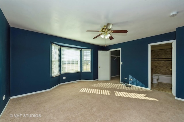 unfurnished bedroom with connected bathroom, ceiling fan, a closet, and light colored carpet