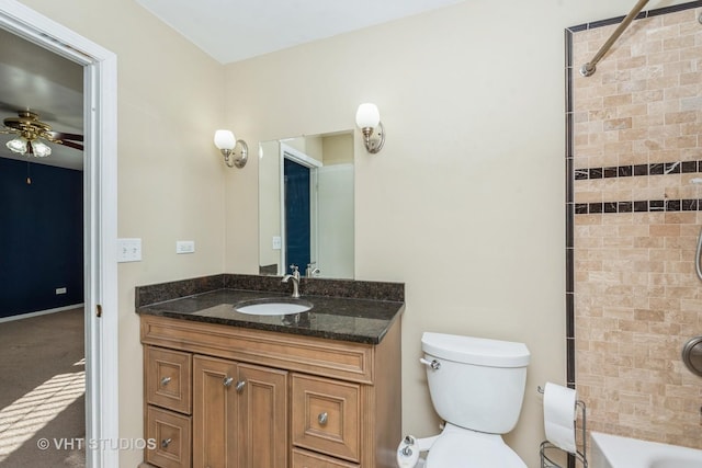 full bathroom with ceiling fan, toilet, vanity, and tiled shower / bath combo