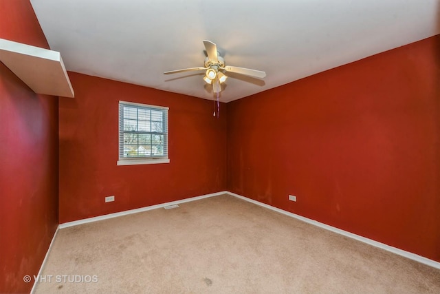 spare room featuring ceiling fan and carpet floors