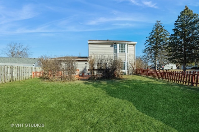 rear view of property featuring a lawn