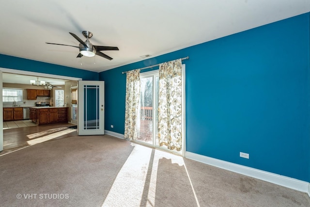 unfurnished living room featuring light colored carpet and ceiling fan