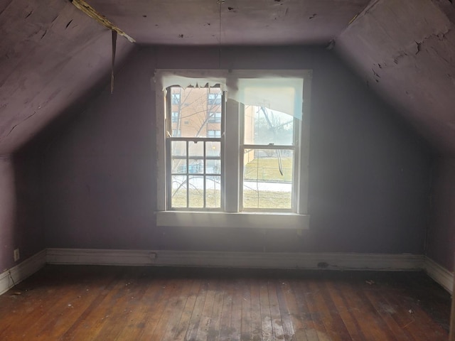 bonus room with dark hardwood / wood-style flooring and lofted ceiling