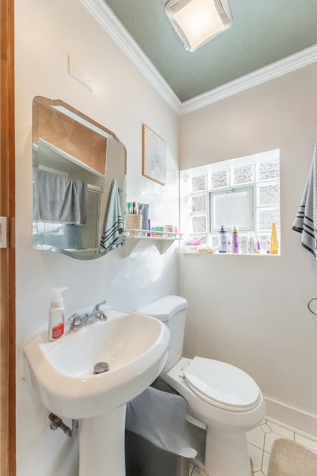 bathroom featuring tile patterned flooring, ornamental molding, and toilet