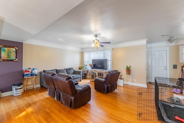 living room featuring ceiling fan, wood-type flooring, and crown molding