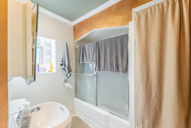 bathroom featuring sink, crown molding, and bath / shower combo with glass door