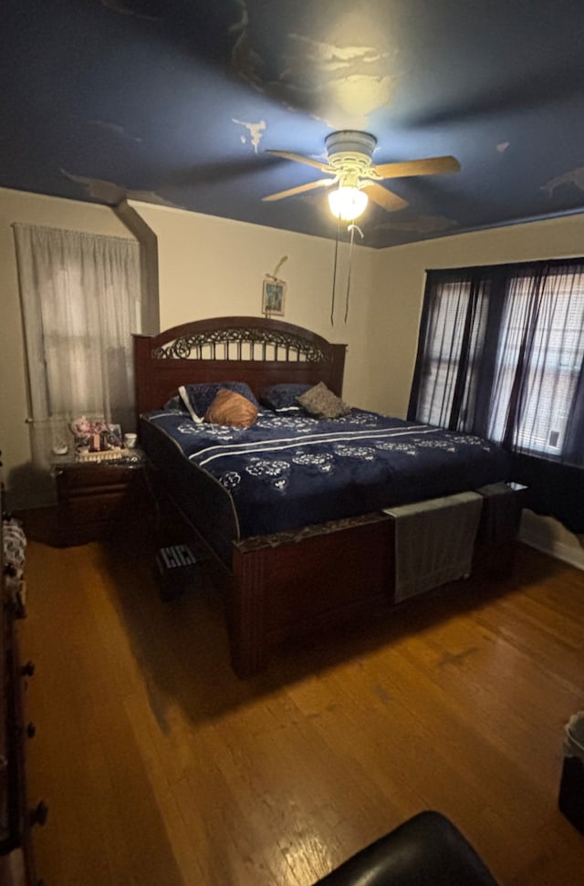 bedroom with hardwood / wood-style flooring and ceiling fan