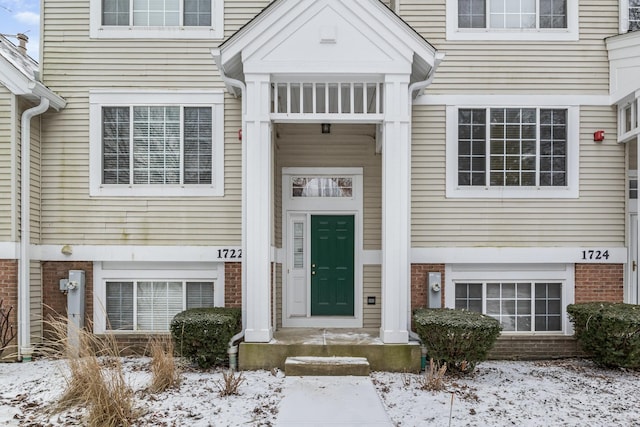 view of snow covered property entrance