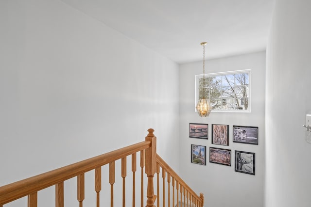 stairway with an inviting chandelier