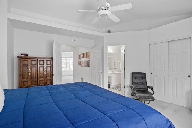 carpeted bedroom with ensuite bathroom, a closet, ceiling fan, and lofted ceiling