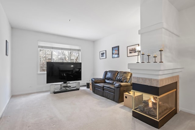 living room with a multi sided fireplace and carpet