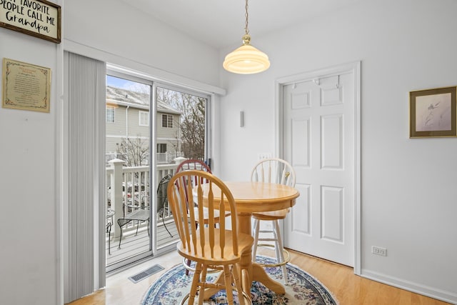 dining space with light hardwood / wood-style flooring