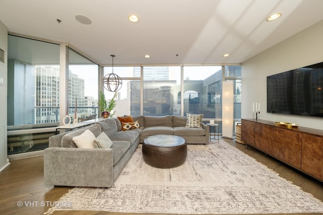 living room featuring hardwood / wood-style flooring, floor to ceiling windows, and a healthy amount of sunlight