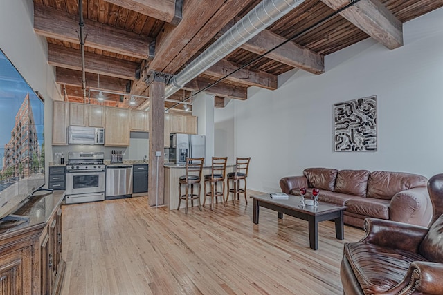 living room featuring beamed ceiling, wood ceiling, and light hardwood / wood-style flooring