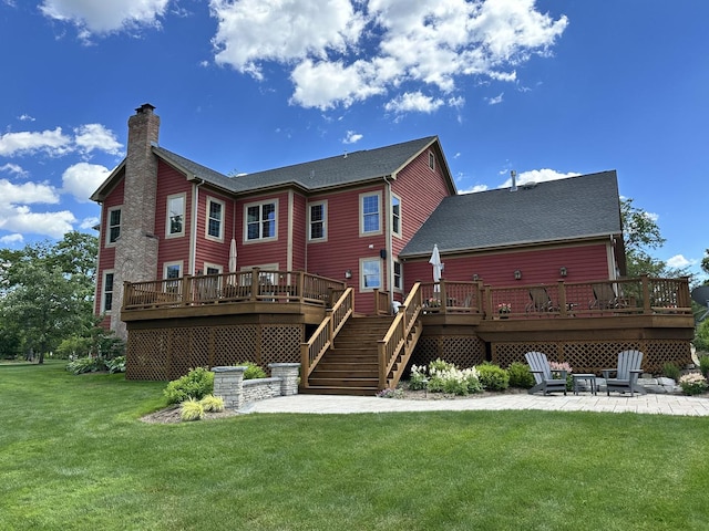 back of property with a patio, a lawn, and a wooden deck