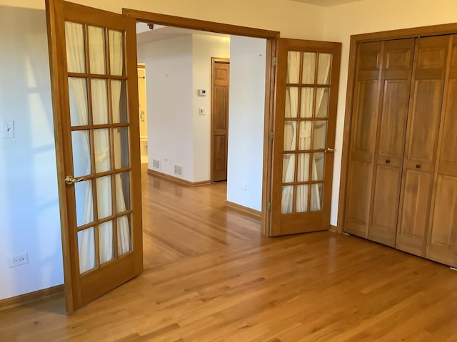 interior space with french doors and light wood-type flooring