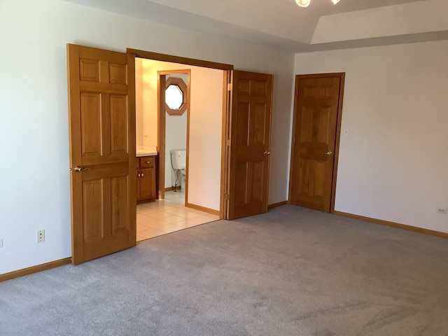 unfurnished bedroom with light colored carpet and ensuite bath