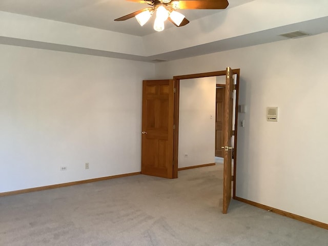 carpeted empty room featuring ceiling fan