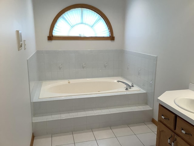 bathroom featuring tiled bath, tile patterned flooring, and vanity