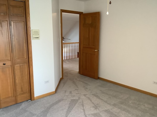 hallway featuring light colored carpet