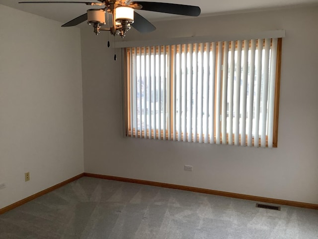 spare room featuring ceiling fan and carpet