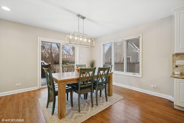 dining space featuring a notable chandelier and hardwood / wood-style flooring