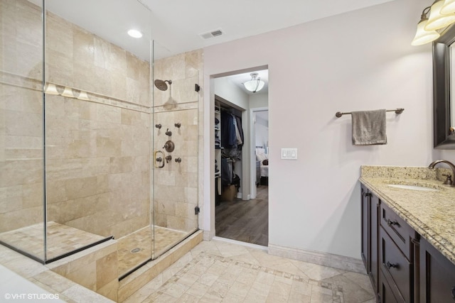 bathroom featuring vanity and tiled shower