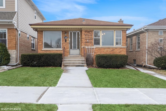 bungalow-style house featuring a front lawn