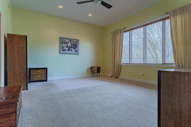 unfurnished bedroom featuring ceiling fan and light colored carpet