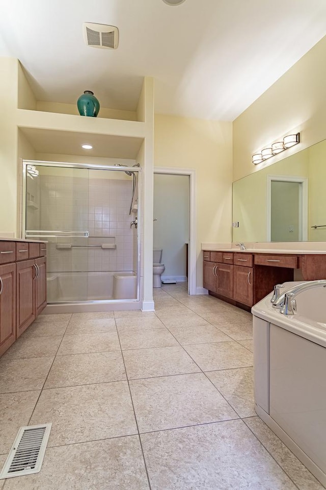 bathroom featuring tile patterned flooring, vanity, and a shower with shower door