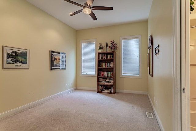 interior space featuring ceiling fan and light carpet