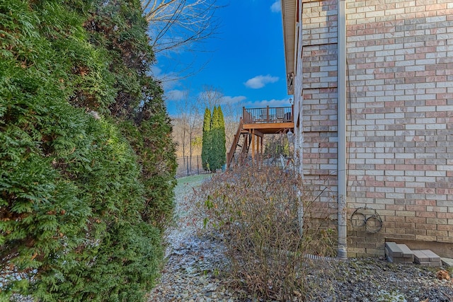 view of home's exterior with a wooden deck