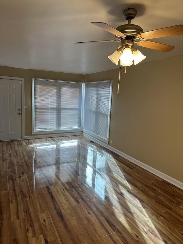 spare room featuring ceiling fan and dark hardwood / wood-style floors