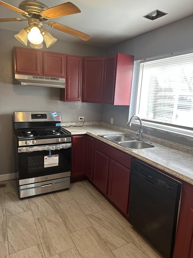 kitchen featuring ceiling fan, sink, black dishwasher, and stainless steel stove