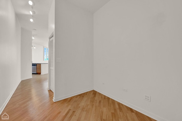 corridor with light hardwood / wood-style floors