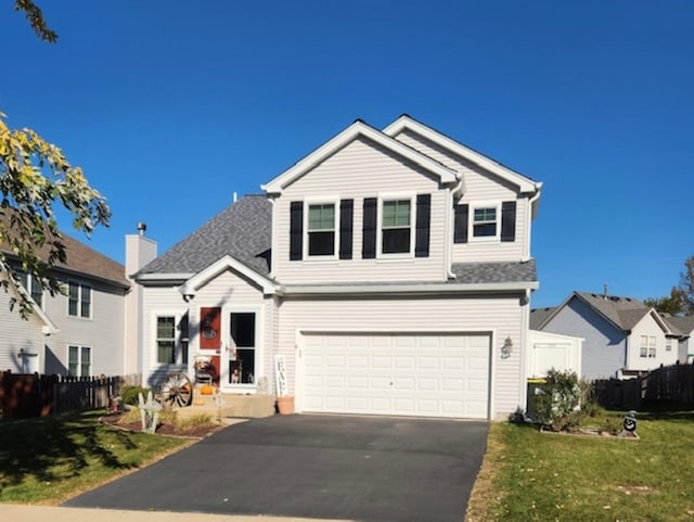 view of front property featuring a front yard and a garage