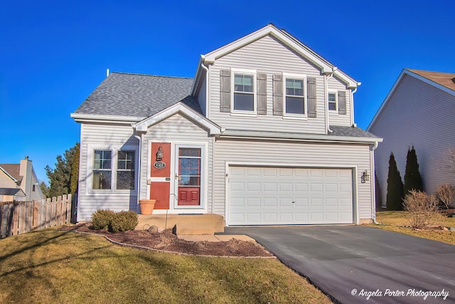 view of front property featuring a garage and a front lawn