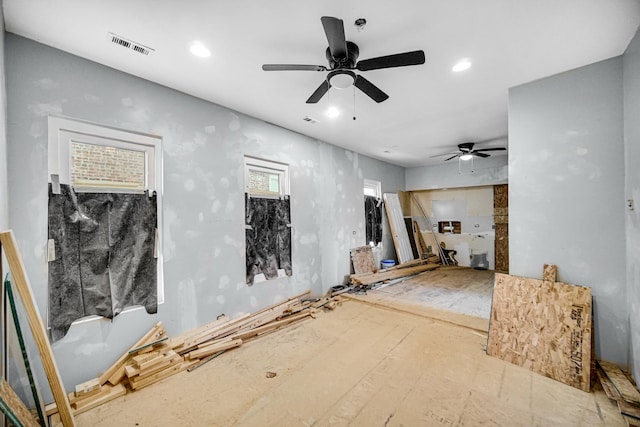 unfurnished living room featuring ceiling fan