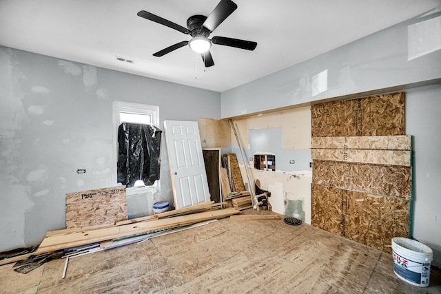 interior space with ceiling fan