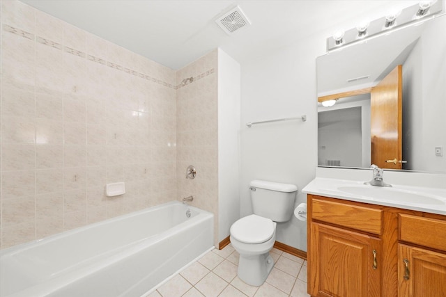 full bathroom with tiled shower / bath, tile patterned flooring, vanity, and toilet