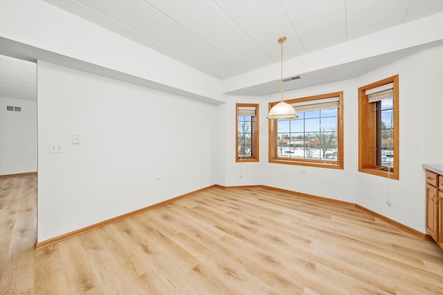 unfurnished dining area featuring light hardwood / wood-style floors