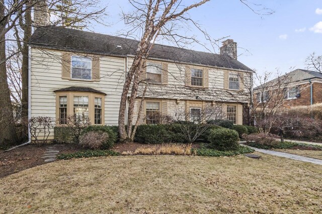 colonial inspired home with a front yard