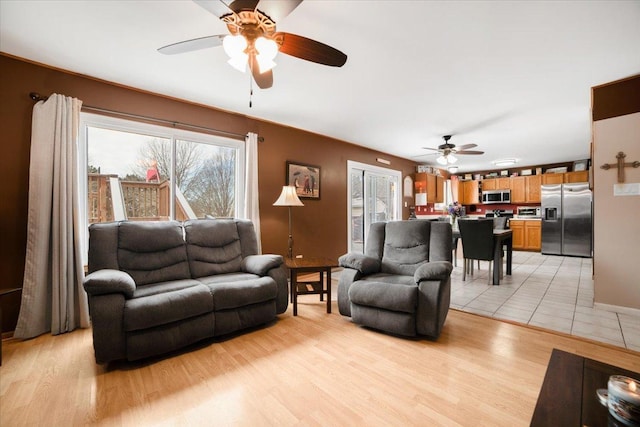 living room with ceiling fan and light hardwood / wood-style floors