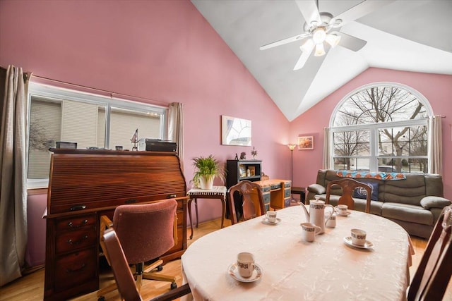 dining space featuring light hardwood / wood-style flooring, high vaulted ceiling, and ceiling fan