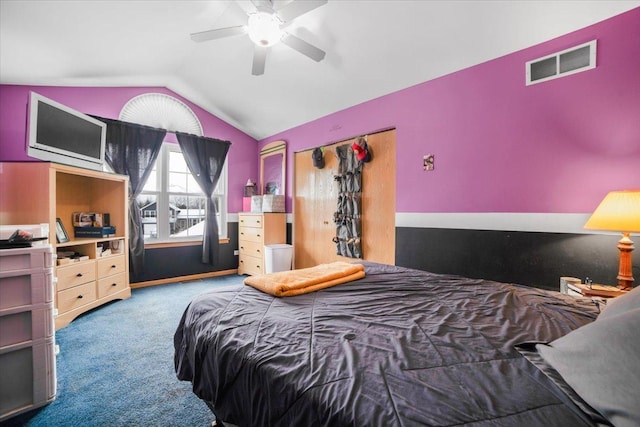 bedroom with ceiling fan, lofted ceiling, and carpet flooring