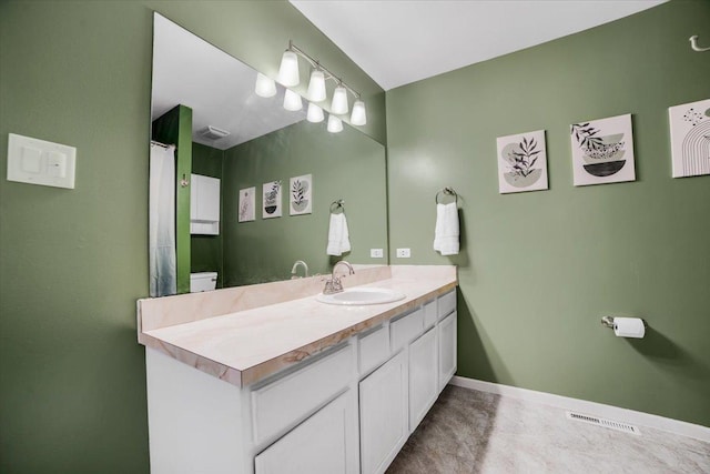 bathroom featuring vanity and toilet