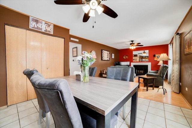 dining area featuring light tile patterned floors and ceiling fan