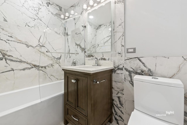 full bathroom featuring vanity, tiled shower / bath, tile walls, and toilet